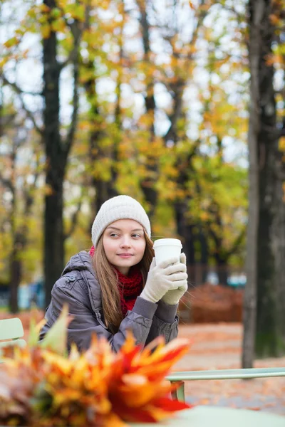 Meisje drinken koffie buitenshuis — Stockfoto