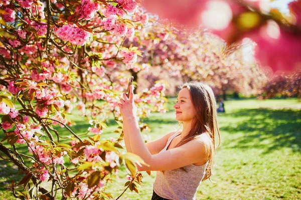 Hermosa Chica Jardín Flores Cerezo Día Primavera Tomando Fotos Grabando —  Fotos de Stock