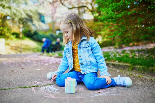 アスファルトの上にカラフルなチョークで愛らしい4歳の少女の図面 子供のための屋外活動 — ストック写真