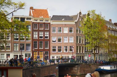 AMSTERDAM, THE NETHERLANDS - MAY 1, 2022: Lots of bikes parked on the bridges and embankments of Amsterdam, the Netherlands