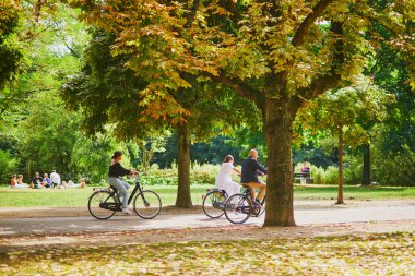 AMSTERDAM, THE NETHERLANDS - AUGUST 18, 2022: People riding bikes in Vondelpark in Amsterdam, the Netherlands