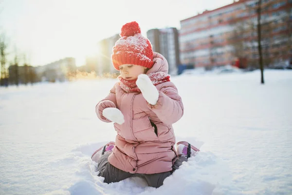 雪の寒い冬の日に美しい冬の公園で楽しんでいる愛らしい未就学児の女の子 雪の中で遊ぶかわいい子供 子供連れの家族のための冬の活動 — ストック写真