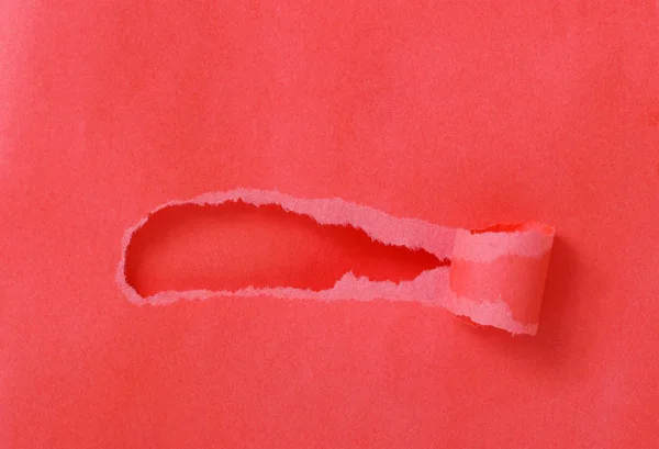 Hole in a red paper. — Stock Photo, Image