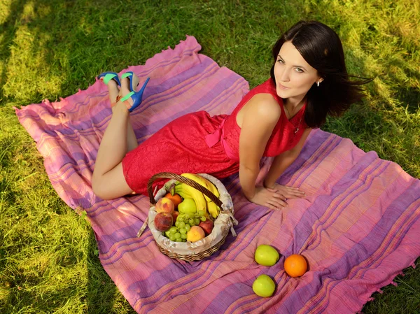 Beautiful girl in a pink dress on a picnic — Stock Photo, Image