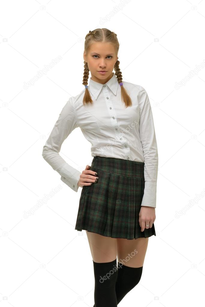 Beautiful blonde girl student in a plaid skirt