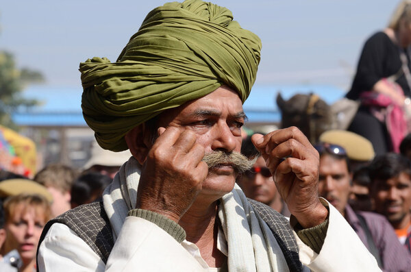 Old man shows his moustache at moustache competition at Pushkar camel fair,India