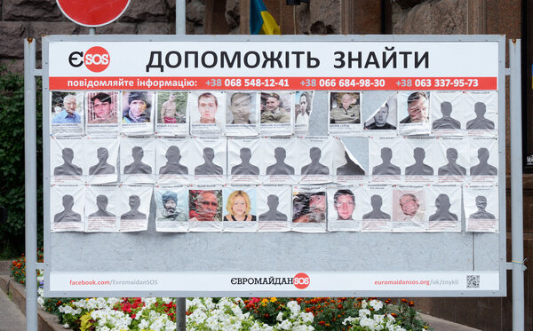 Poster with photos of missing people ,saying "Help to find them" at Maydan Nezalezhnosti square,Kiev