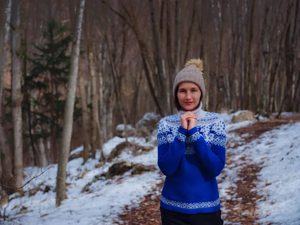 Piękna kobieta stojąca wśród drzew w zimowym lesie — Zdjęcie stockowe