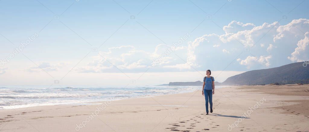 Backpacker asian female on Patara sand dunes beach