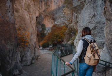 Mutlu Asyalı kadın, Türkiye 'deki Saklikent Vadisi boyunca aktif yürüyüş yapıyor. Yeni deneyim ve açık hava eğlencesi.