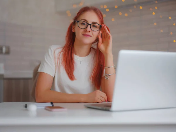 stock image pleasant happy young female freelancer working on computer at home. Attractive woman studying online using laptop software, web surfing information or online shopping.