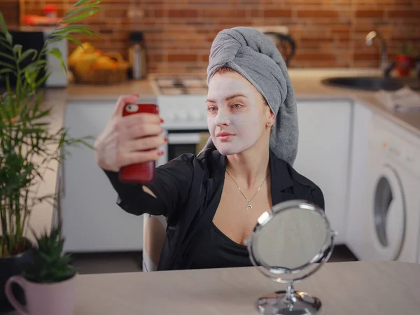 Young Woman Cream Mud Mask Her Face Taking Selfie Her — стоковое фото