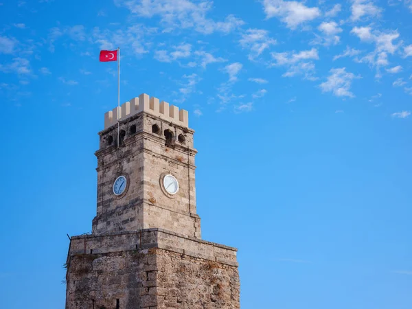 Antalya, Turkey - November 2021: Antalya Saat Kulesi, Stone crenellated tower of the 9th century with a clock, travel to old town Kaleci. discover interesting places and popular attractions and walks
