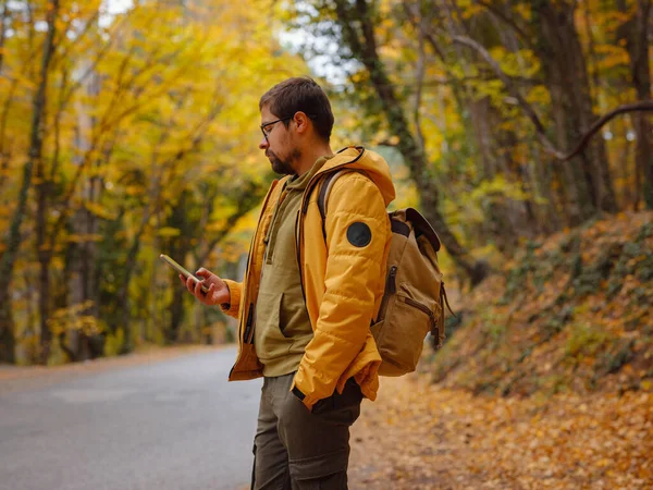 Young Handsome Man Autumn Forest Smartphone Young Hipster Guy Backpack — Fotografia de Stock