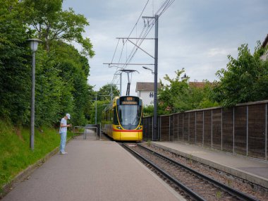 Basel, İsviçre - 4 Temmuz 2022: Şehirde toplu taşıma. Banliyö sarı treni, yaz günü durakta.
