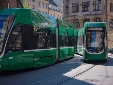 Basel, Switzerland - July 8 2022: public transport in the city. Green tram in street of Basel city center. Basels green and yellow trams have become an inseparable part of the cityscape.