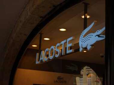 Bern, Switzerland - July 4 2022: Closeup of Lacoste sign on store front, Lacoste is the famous french chain of luxury polo