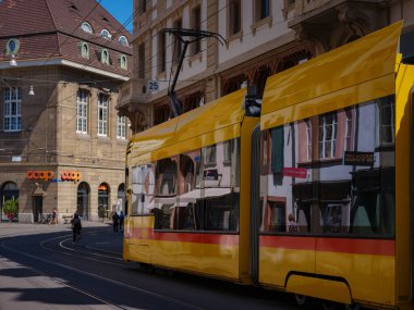 Basel, Switzerland - July 8 2022: public transport in the city. Yellow tram in street of Basel city center. Basels green and yellow trams have become an inseparable part of the cityscape.