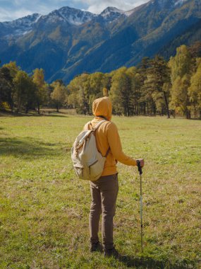 trip to Caucasus mountains, Arkhyz, Teberdinsky reserve. concept of discovery and exploration of wild places in early autumn. Man hiking in mountains with backpack and photo camera