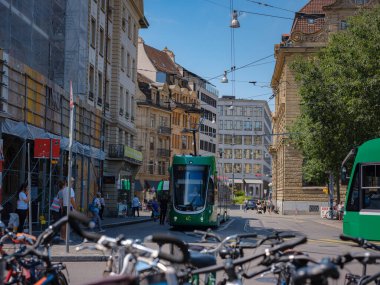 Basel, Switzerland - July 4 2022: public transport in the city. Green tram in street of Basel city center. Basels green and yellow trams have become an inseparable part of the cityscape.