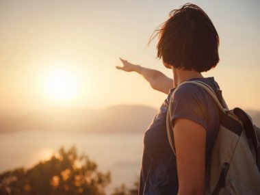 Travel to Turkey, viewpoint over Dalyan Iztuzu Beach. . Smiling woman taking break on hiking trip looking at view at sunset. Explore natural wonders of Turkey