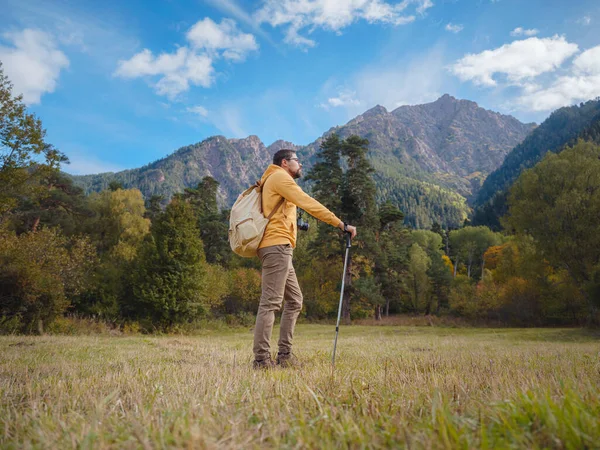 trip to Caucasus mountains, Arkhyz, Teberdinsky reserve. concept of discovery and exploration of wild places in early autumn. Man hiking in mountains with backpack and photo camera