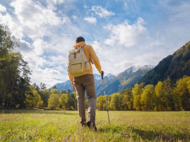trip to Caucasus mountains, Arkhyz, Teberdinsky reserve. concept of discovery and exploration of wild places in early autumn. Man hiking in mountains with backpack and photo camera