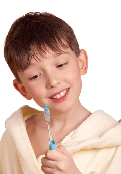 A boy brushing his teeth after bath — Stock Photo, Image