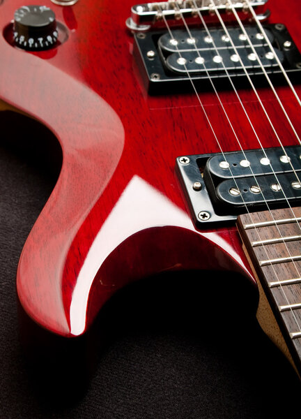 Detail of a wine red color electric guitar.