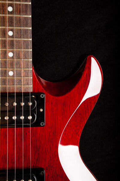Detail of a wine red color electric guitar.