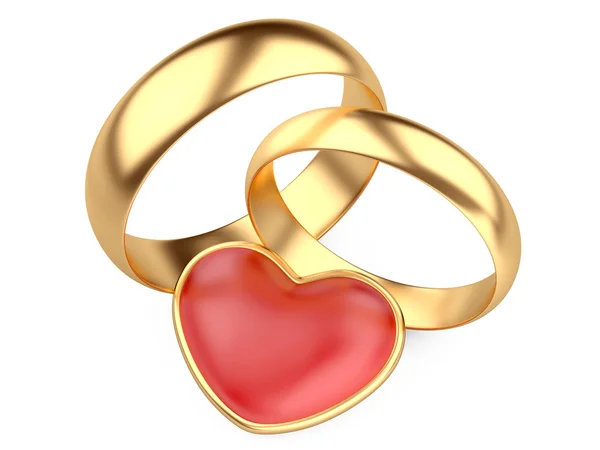 Χρυσά γαμήλια δαχτυλίδια και κόκκινη καρδιά — Φωτογραφία Αρχείου