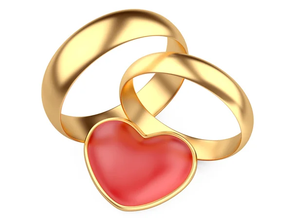 Anillos de boda de oro y corazón rojo — Foto de Stock