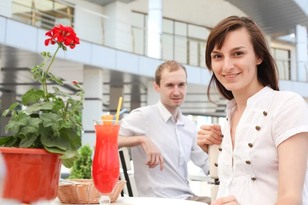 Beautiful girl in a cafe. Man looking at her — Stock Photo, Image