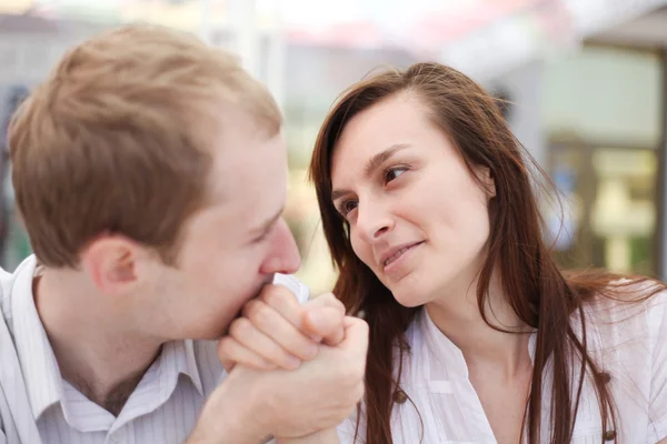 Young man kissing hand of his girlfriend on date — Stock Photo, Image