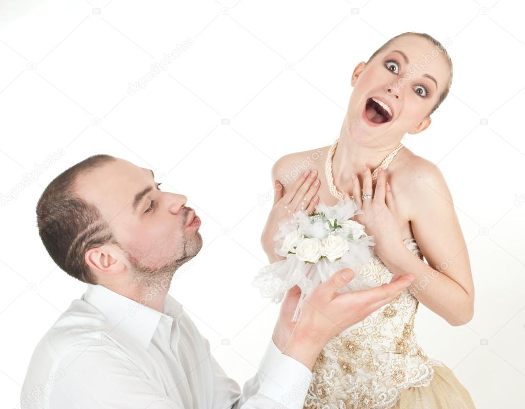 Beautiful wedding couple - groom and surprised bride