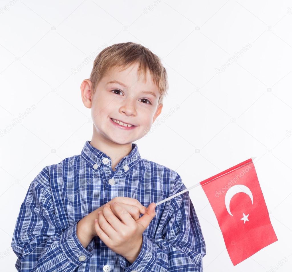 A little boy with Turkish flag on white background
