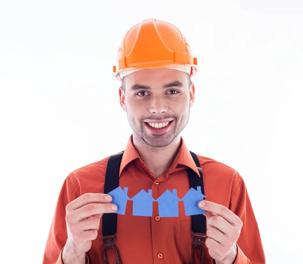 Um construtor segurando casas de papel . — Fotografia de Stock