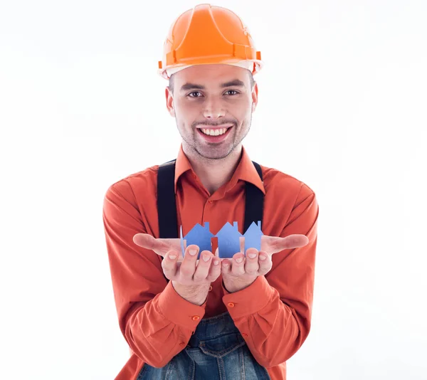 A builder man holding paper houses. — Stock Photo, Image