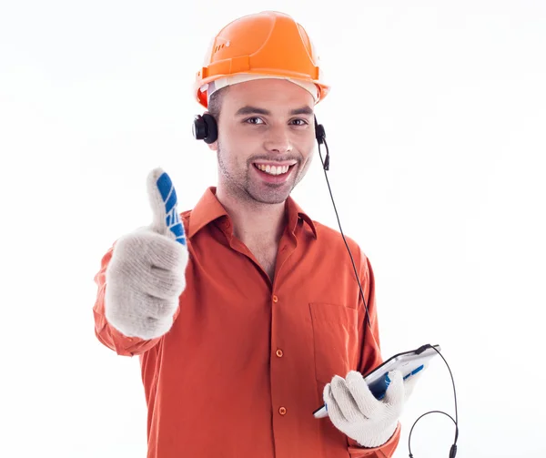 Um construtor com telefone e dando um polegar para cima . — Fotografia de Stock