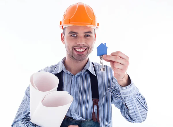 A builder man holding a key and a paper house. Stock Photo