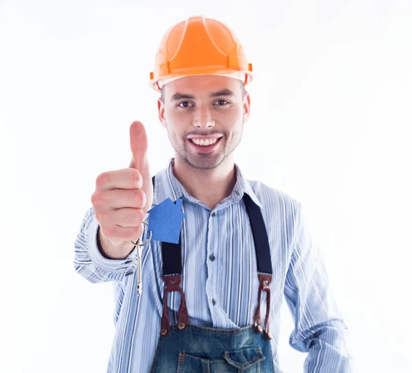 A builder man holding a key and a paper house. Stock Picture
