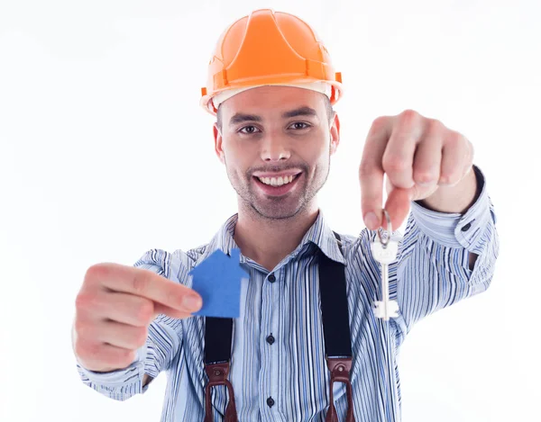 A builder man holding a key and a paper house. Stock Photo