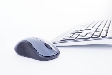 A keyboard and wireless mouse on the white background clipart