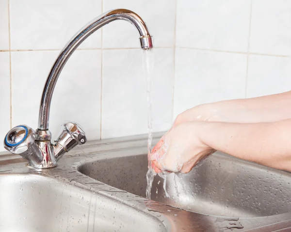 Female hands in soap under the running water — Stock Photo, Image