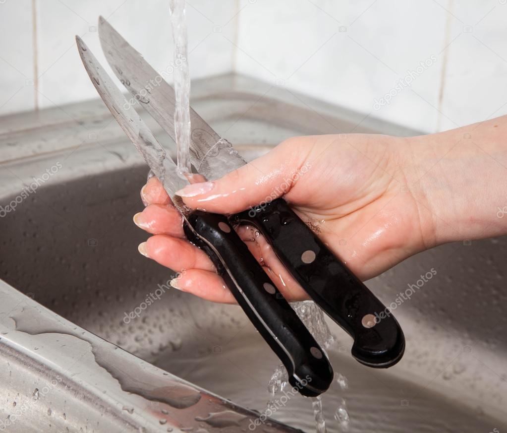 washing of the knives stock photo djemphoto 26814717
