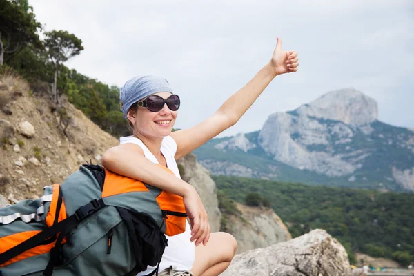 Young happy woman with backpack relaxing — Stock Photo, Image