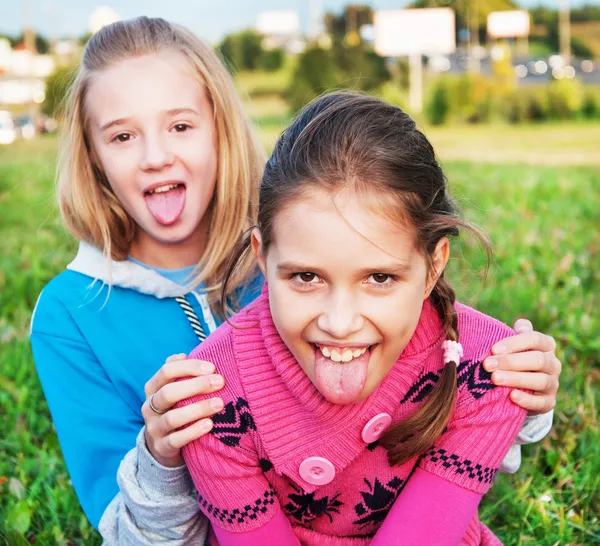 Little girls showing the tongue — Stock Photo, Image