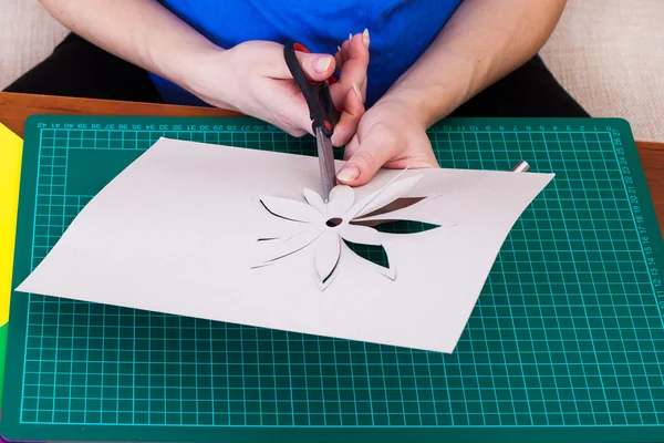 Woman's hand cutting out flower — Stock Photo, Image