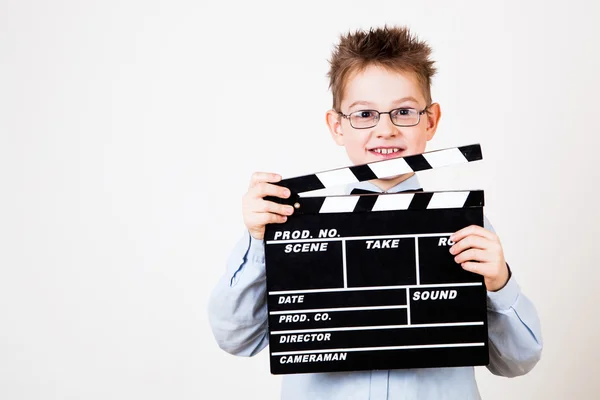 Boy holding clapper board — Stock Photo, Image
