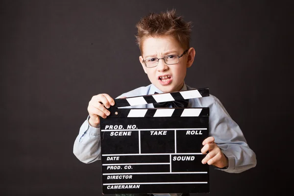 Little boy holding clapper board in hands. — Stock Photo, Image